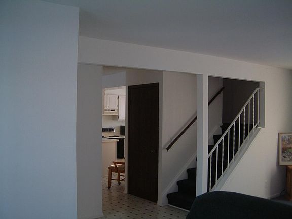 From Living Room Diagonally see the kitchen and Stairway up to 2 Bedrooms and Bath