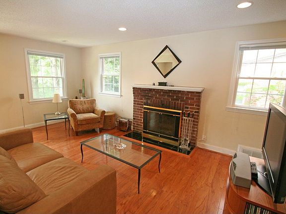 Living room with hardwood floors and fireplace!