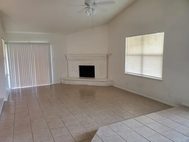 Living area with fireplace, sliding glass door looks onto golf course