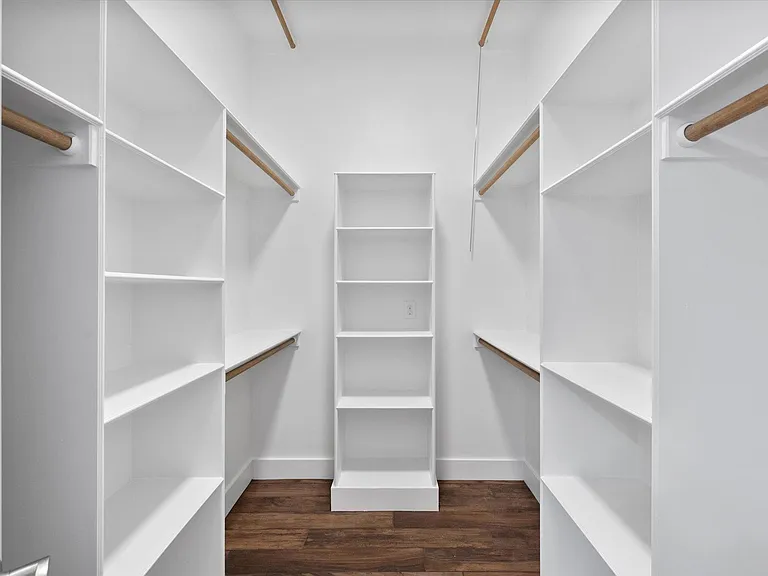 Large primary closet with ample organized space