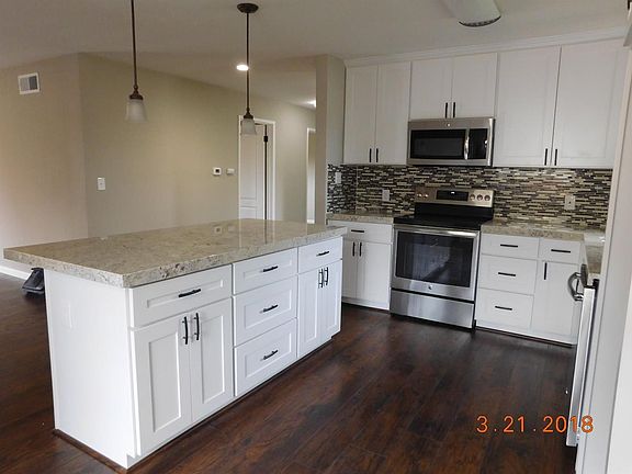 Island has been added for more work space and doubles as extra seating. This seller thought of everything!  This is the perfect space for family gatherings. Bar area seats 4 very comfortably.