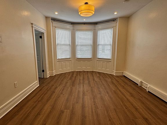 Living Room (Actual Room): Spacious, open-concept living area with abundant natural light and a charming bay window_perfect for relaxing or entertaining
