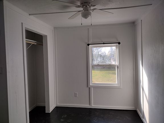 Bedroom - curtain rods installed and shelf with rod in closet