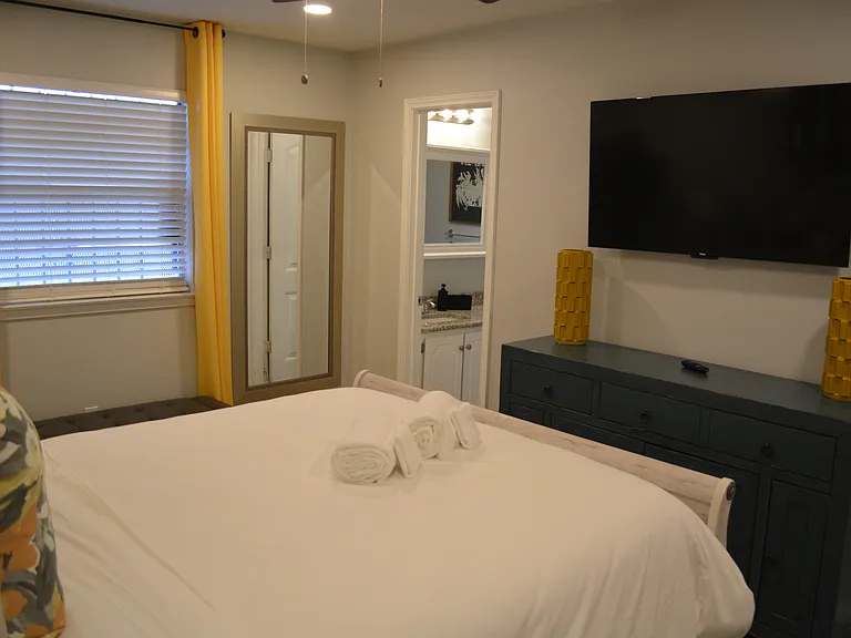 Bedroom 1 - a queen bed, smart tv and attached to bathroom 2.