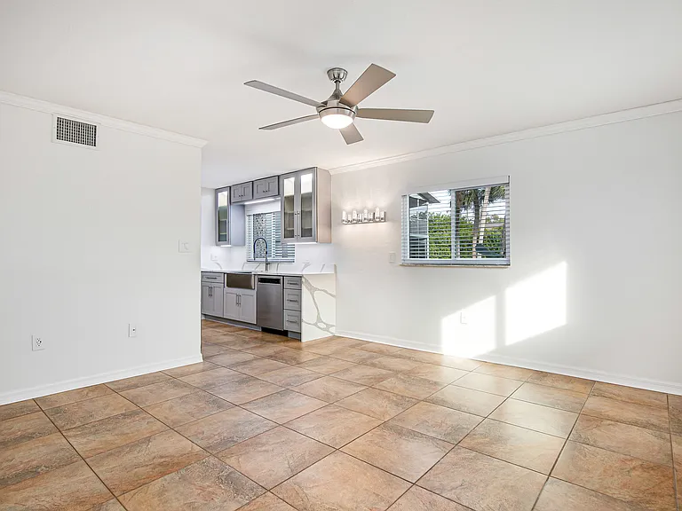 Living room. All ceiling fans in the unit can be controlled by wall switches or by remote controls.