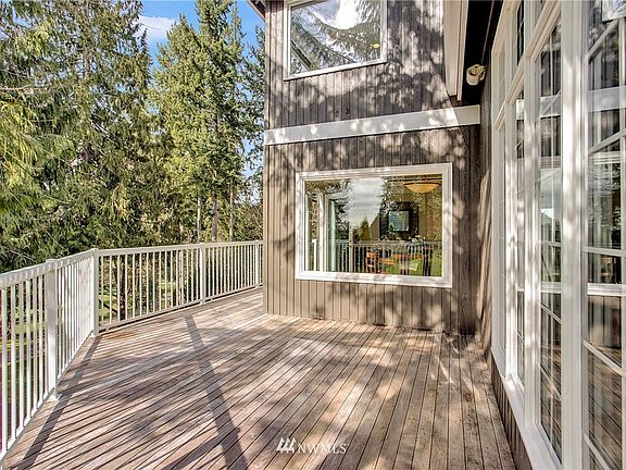 Step out to the deck overlooking golf course from your dining room