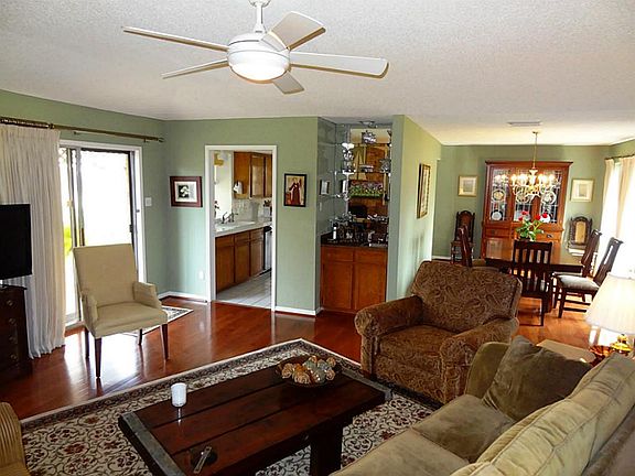 Den is open to dining and kitchen.  Sliding door to wood deck.  Raised ceiling and fan.