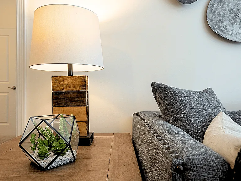 Modern, cozy living spaces with stylish decor, luxury flooring, and warm wood accents for a welcoming feel.