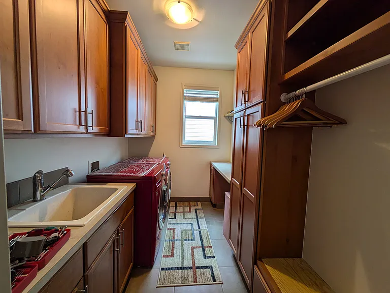 Laundry with cabinets.