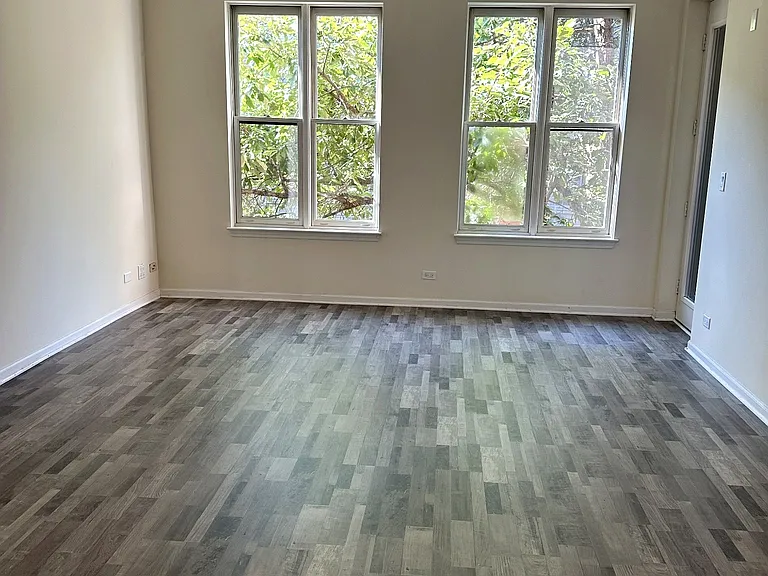 Living Room (unstaged). New floors were installed 8/6/26. 2" cordless blinds are being installed in all windows throughout the residence: