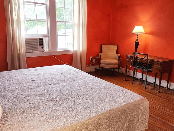 2nd Floor Orange Side yard view, 2 windows, King bed, dresser, wood floor, window AC/Heat unit, dedicated work station, NO TV