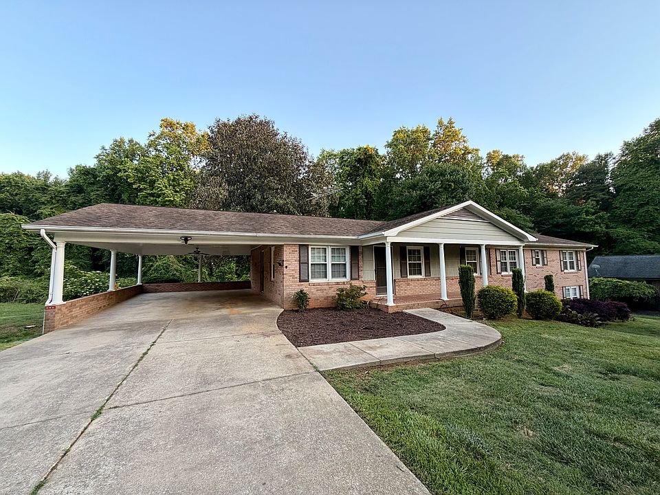 Front of the brick home with oversized 2 car carport