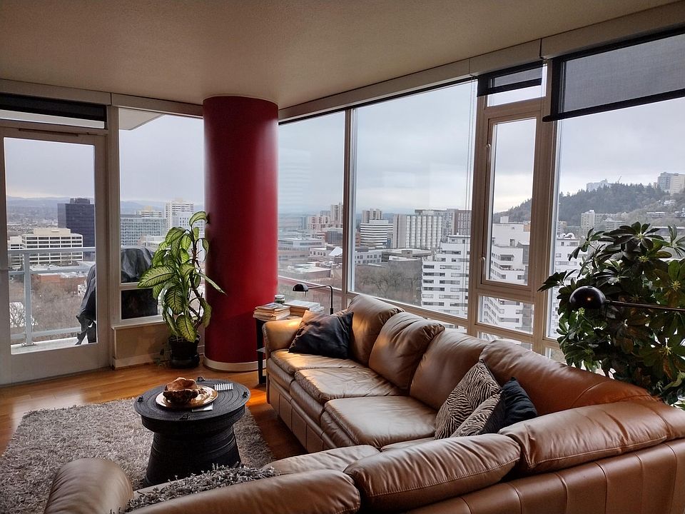 Living Room glass on two sides. With deck overlooking city.