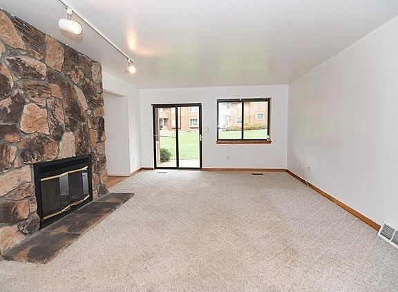 Oversized living room with sliding glass door to patio and sprawling yard.
