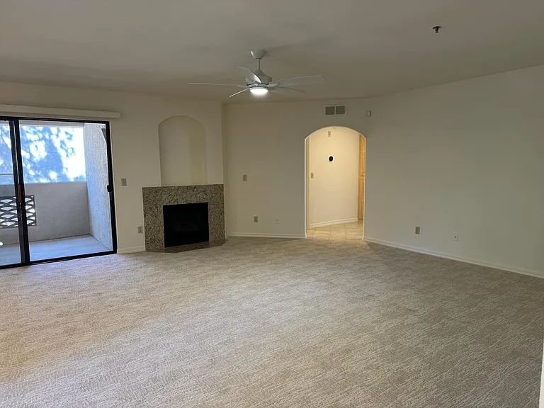 An arched hallway leads to the bathroom, linen closet, and bedroom.