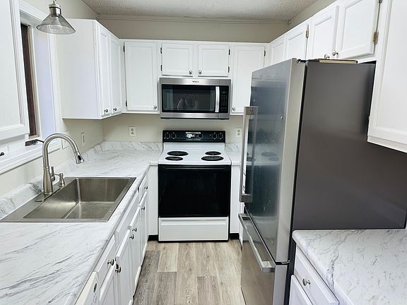 Kitchen - Newly renovated with brand new refrigerator, sink and microwave.
