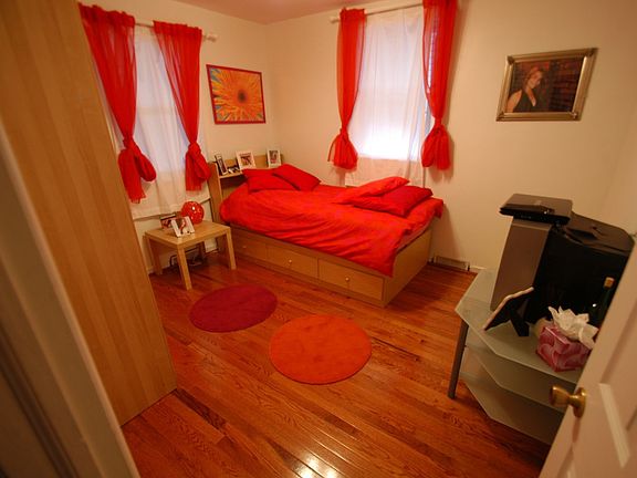 Bright guest bedroom with beautiful floors and recess lights.