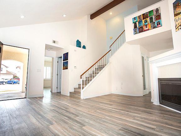 Living room w/main entrance, stairs, bathroom entrance, and entrance to downstairs bedroom