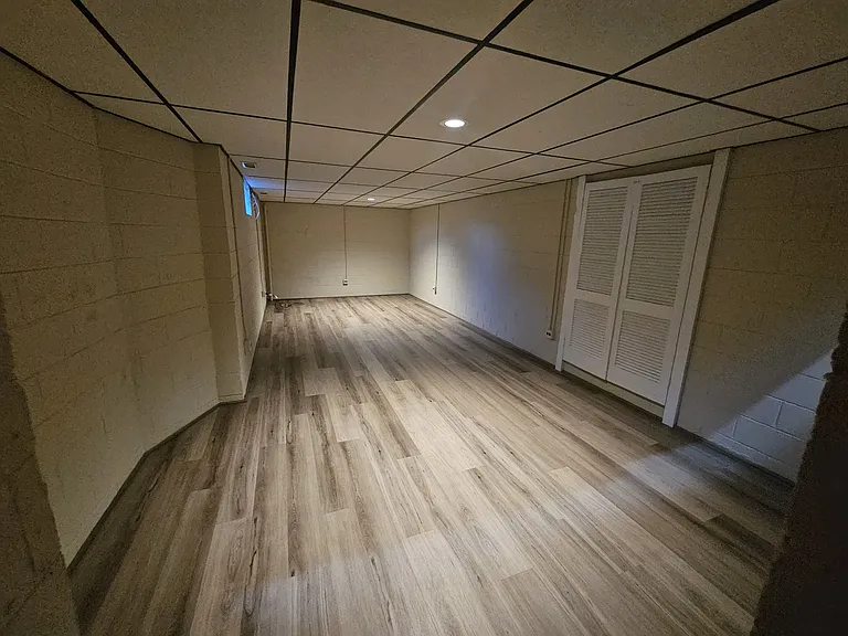 27x11 ft Basement area with new paint and new LVP flooring.