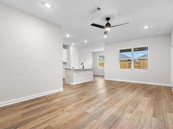 The kitchen overlooks the spacious living area.