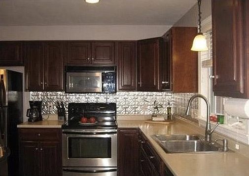 Kitchen offers stainless appliances with tile flooring.