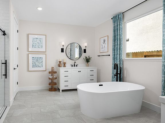 Primary bath with freestanding vanities and tub