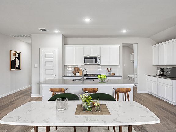 Kitchen in the Heisman home plan by Trophy Signature Homes - REPRESENTATIVE PHOTO