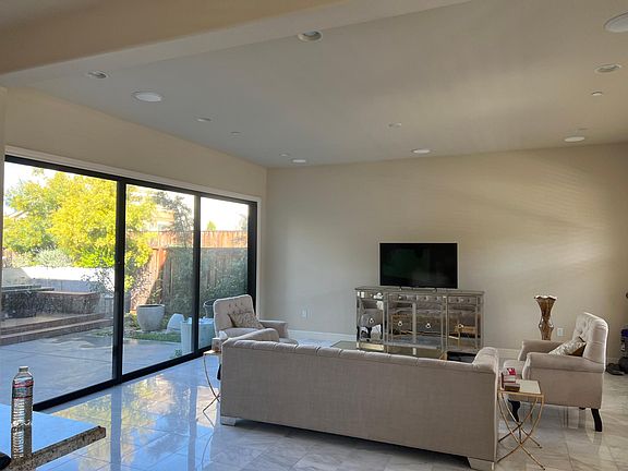 Living room with marble flooring and high ceiling