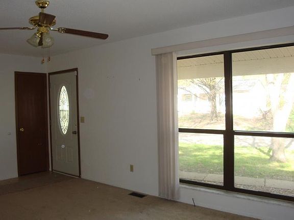 Living room with ceiling fans throughout home.