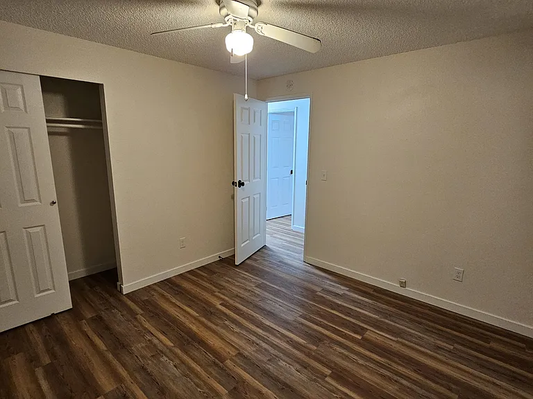 Third bedroom facing front yard with ceiling fan.