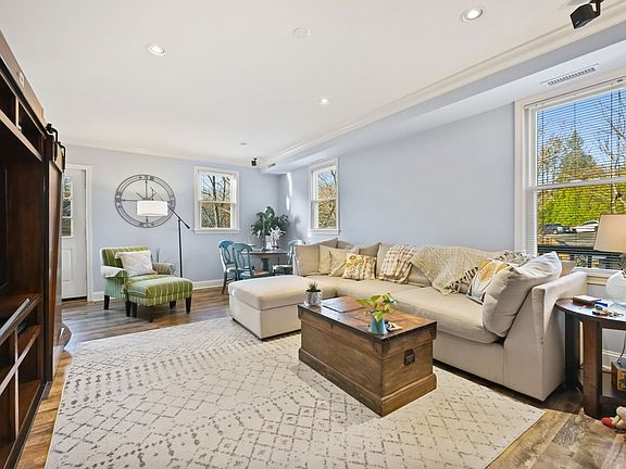 Bright living space with hardwood floors, recessed lighting, wrap around deck.