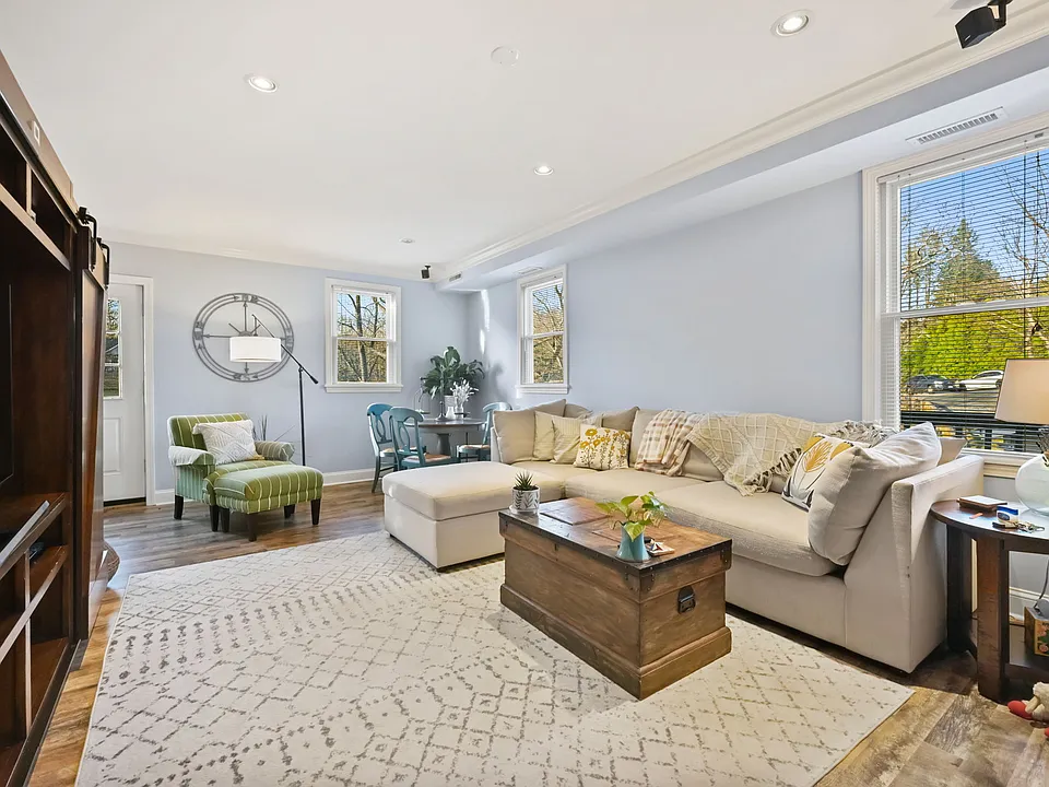 Bright living space with hardwood floors, recessed lighting, wrap around deck.