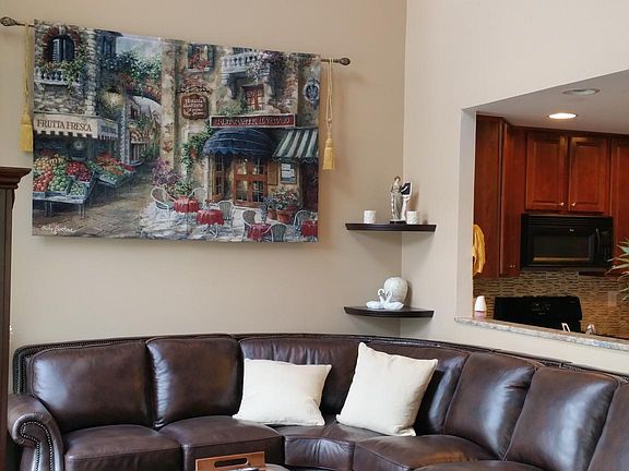 Vaulted ceiling above the living room with accent lighting and full height windows which allow tons of natural light.