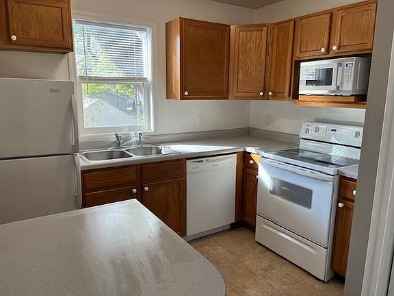 Kitchen showing all appliances, breakfast bar shown in left front.