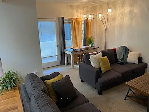 middle floor living room looking at study area and balcony door