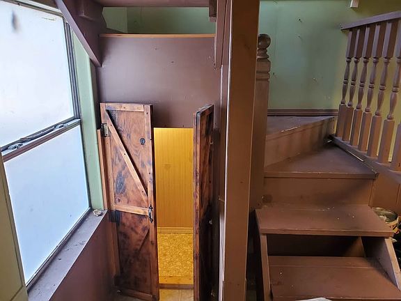 Stairs up to bedroom and office area, plus storage under stais.