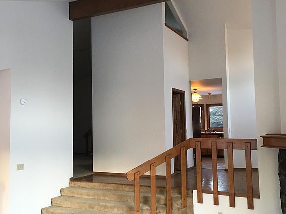 Living room towards kitchen and dining.