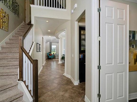 As soon as you enter this gorgeous foyer you are drawn into this home. It boasts Elegant raised panel doors throughout, diagonal  Mohawk premium tile and Designer lighting package. At left you have a large entry closet and the double doors at right lead t