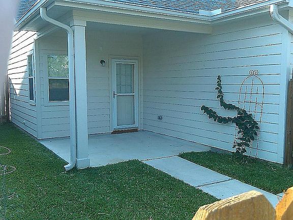 View of the backyard area with large covered patio