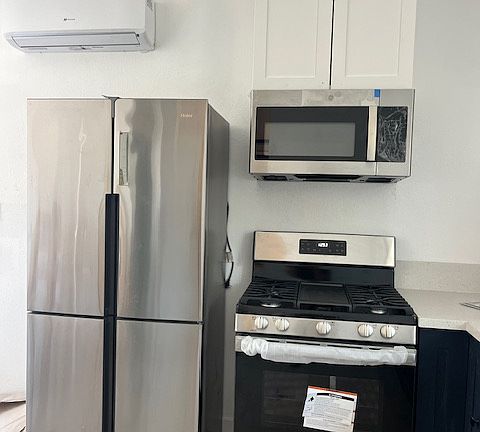 There is a mini split, counter depth fridge, gas stove and microwave range