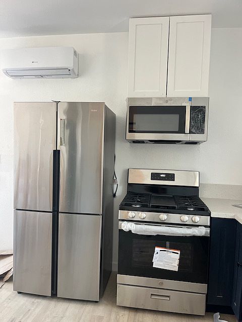 There is a mini split, counter depth fridge, gas stove and microwave range