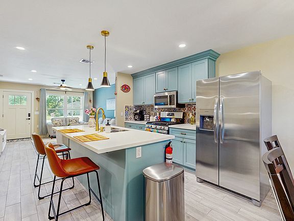 Kitchen with full size refrigerator with water and ice maker.