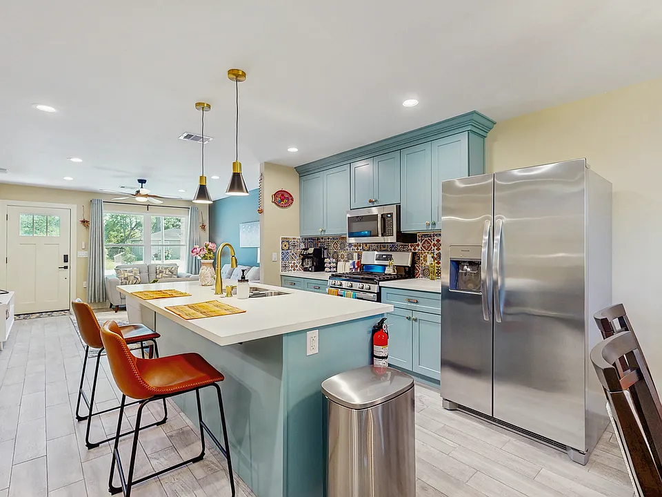 Kitchen with full size refrigerator with water and ice maker.