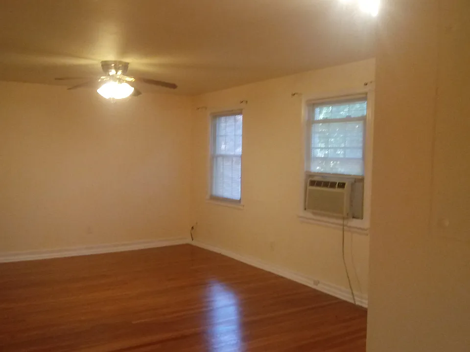 Living area w/ceiling fan attached to dining area