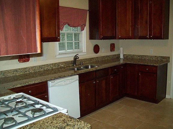 Kitchen opens to either a sunny breakfast room and back deck, or formal dining room. Includes side b