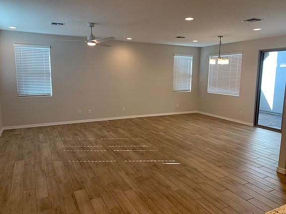 Great room / Living room and dining area. Large Fanimination fan with wall controls.