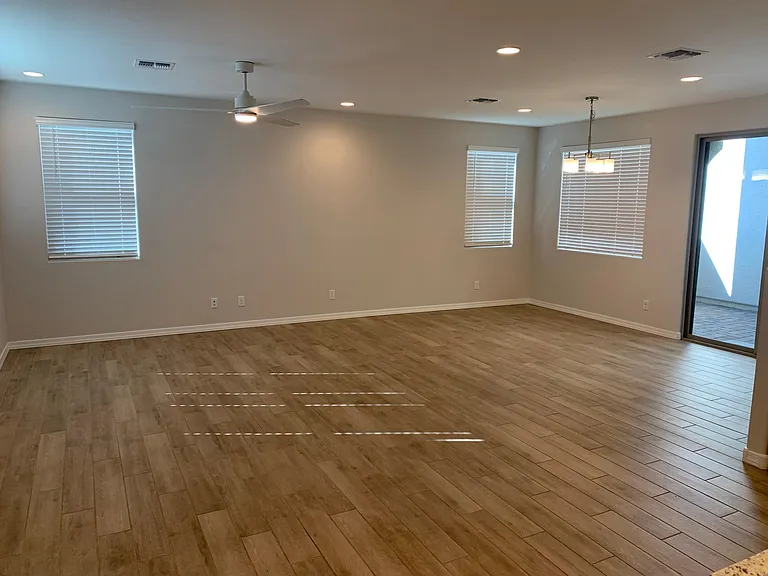 Great room / Living room and dining area. Large Fanimination fan with wall controls.