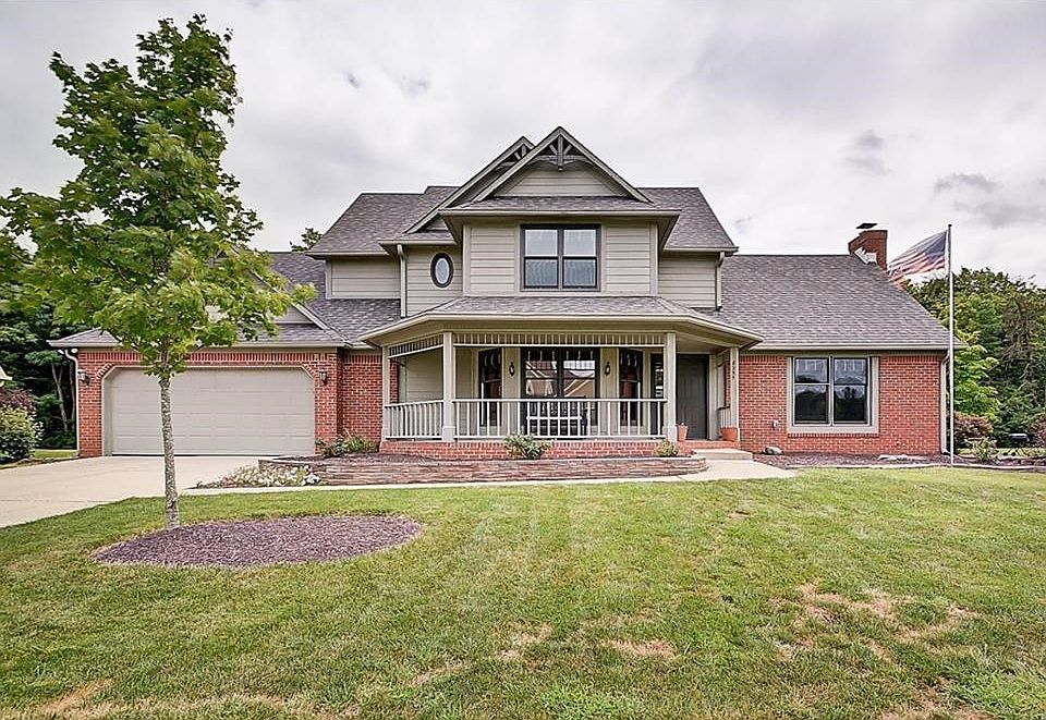 Front elevation features upgraded brick and large covered front porch.