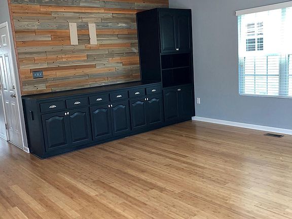Built in family room cabinets with wood accent wall
