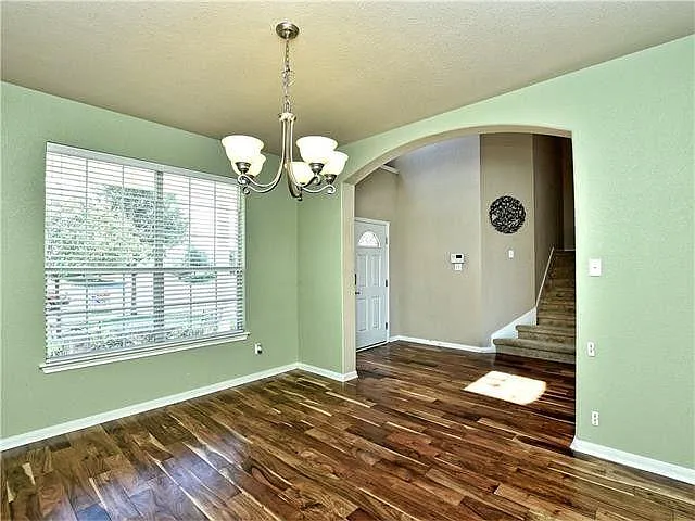 from the front door into the formal dining or office, whichever is preferred. Again, the colors in the flooring are exaggerated in this photo, amplifying the rich tones